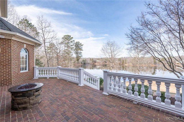 view of patio / terrace featuring a water view and an outdoor fire pit