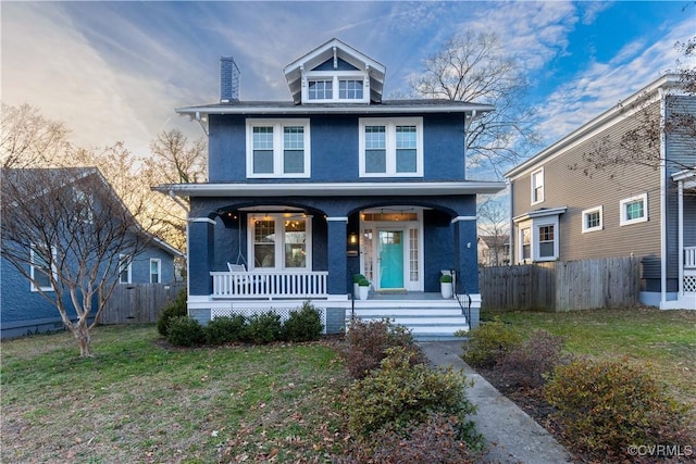 view of front facade with a front yard and a porch