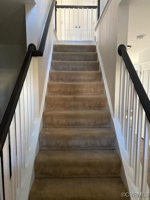 stairs featuring wood finished floors