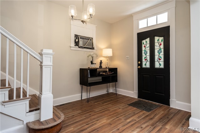 entryway with dark hardwood / wood-style flooring and an inviting chandelier