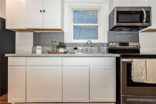 kitchen with white cabinetry, appliances with stainless steel finishes, and sink