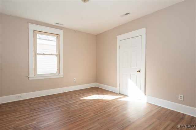 empty room with hardwood / wood-style flooring