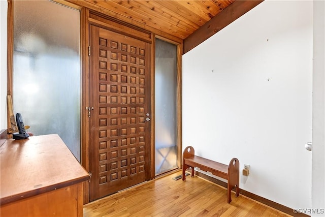 foyer entrance with wooden ceiling and light hardwood / wood-style floors