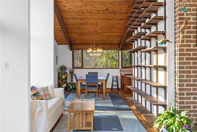 interior space featuring an inviting chandelier, vaulted ceiling with beams, and wooden ceiling