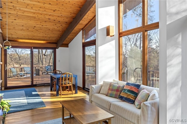 sunroom / solarium with wood ceiling, a wealth of natural light, and lofted ceiling with beams