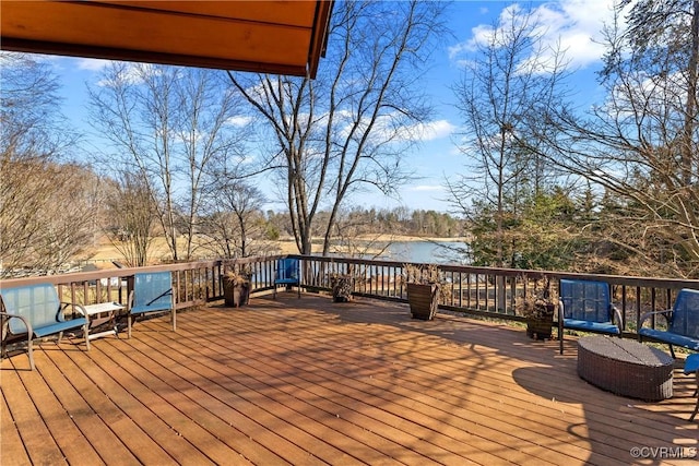 wooden terrace featuring a water view