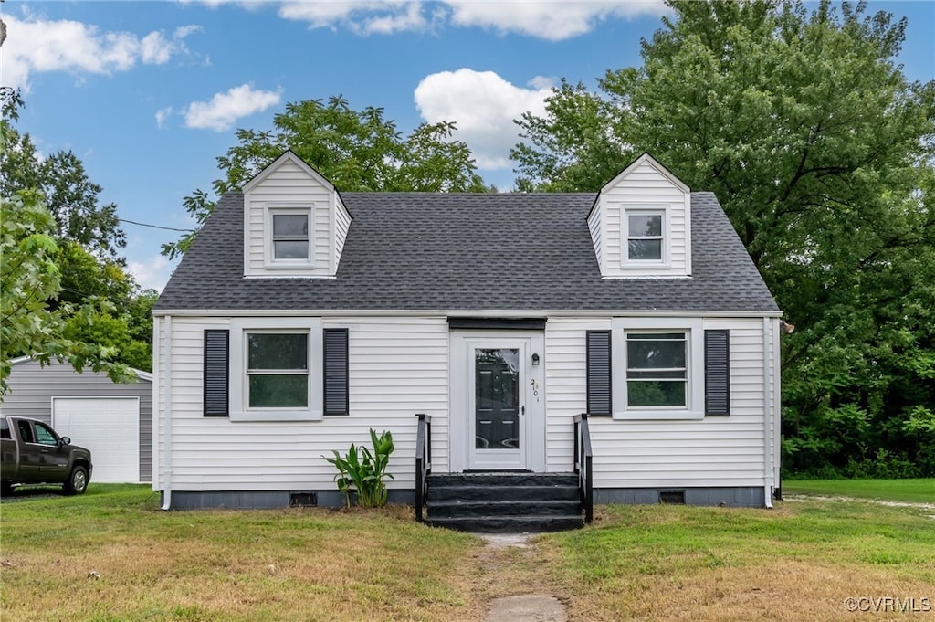 new england style home with a garage, an outdoor structure, and a front lawn