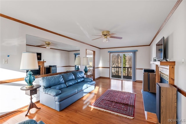 living room with crown molding, hardwood / wood-style floors, and ceiling fan