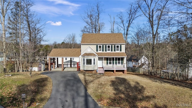 view of front of house featuring a storage shed and covered porch