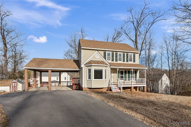 view of front of property with a porch and a storage shed