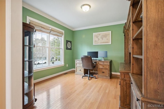 office space with ornamental molding and light hardwood / wood-style floors