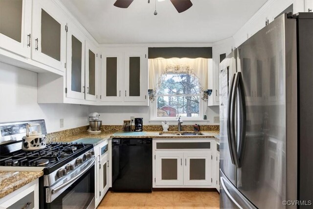 1270 Riverview Dr, West Point, VA 23181 - kitchen with appliances with stainless steel finishes, a sink, light stone counters, ceiling fan, and white cabinets