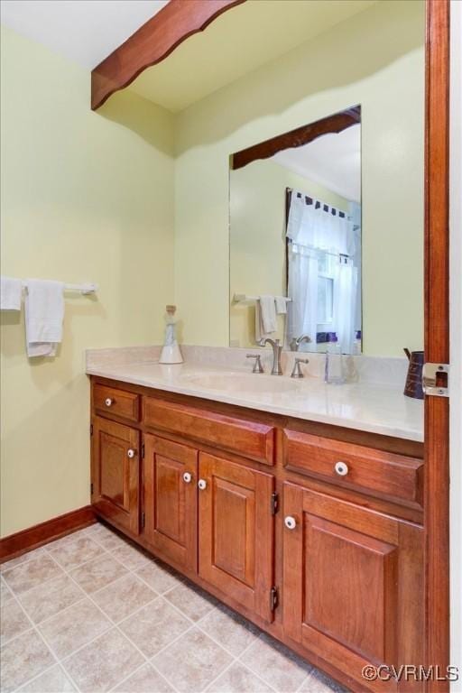 1270 Riverview Dr, West Point, VA 23181 - bathroom featuring vanity, tile patterned flooring, beam ceiling, and baseboards