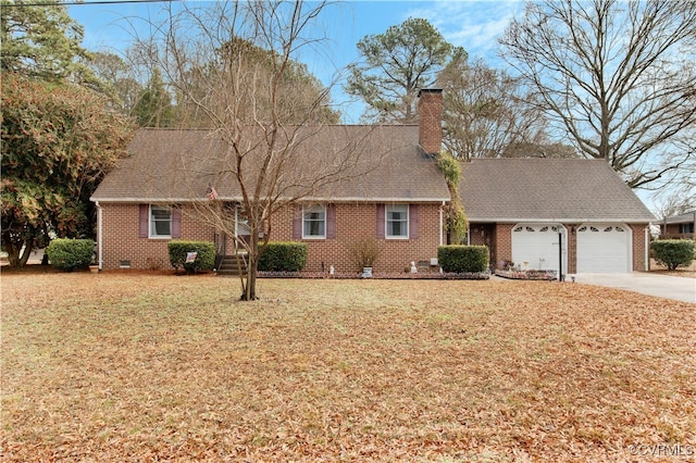 1270 Riverview Dr, West Point, VA 23181 - view of front of home featuring an attached garage, a front yard, brick siding, concrete driveway, and a chimney