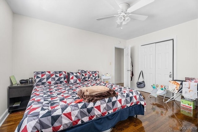 bedroom with dark wood-type flooring, a closet, and ceiling fan