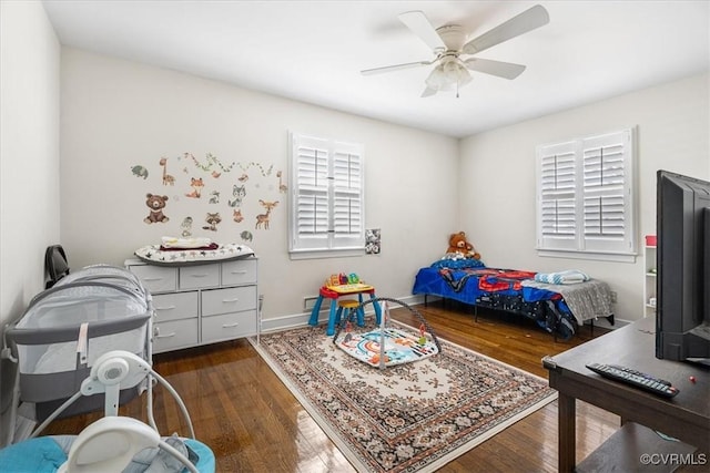 bedroom with dark wood-type flooring and ceiling fan