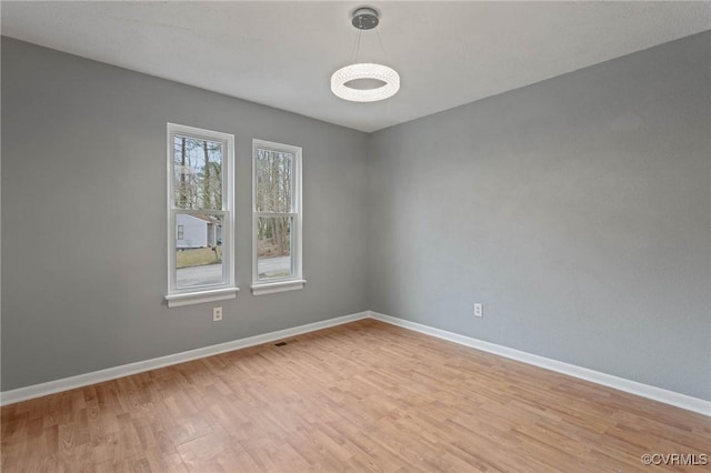 spare room featuring light hardwood / wood-style flooring