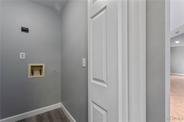 washroom featuring hookup for a washing machine and dark hardwood / wood-style flooring