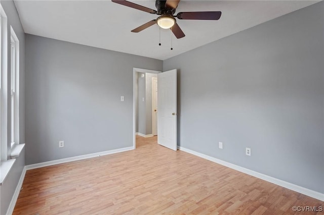 spare room with ceiling fan and light wood-type flooring