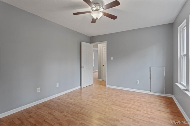 empty room featuring ceiling fan and light wood-type flooring