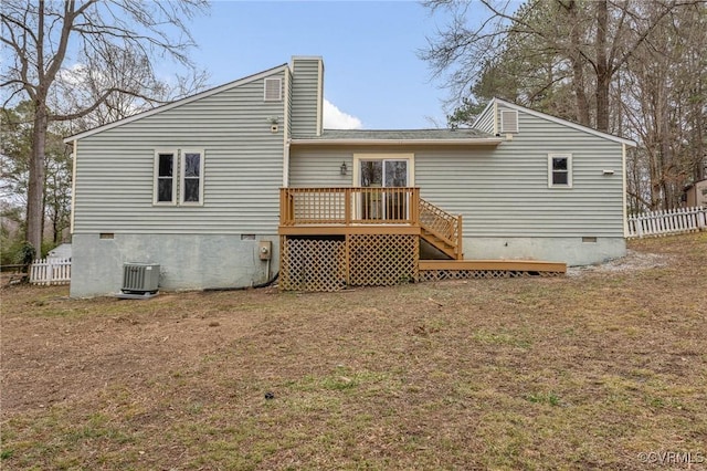 rear view of property with a wooden deck, a yard, and central AC