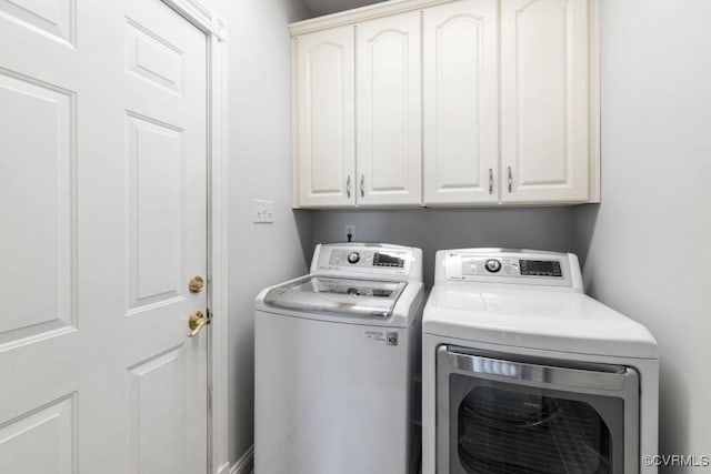 washroom featuring cabinets and independent washer and dryer