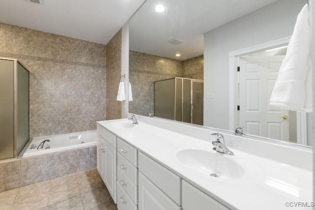 bathroom with tile patterned floors, independent shower and bath, and vanity