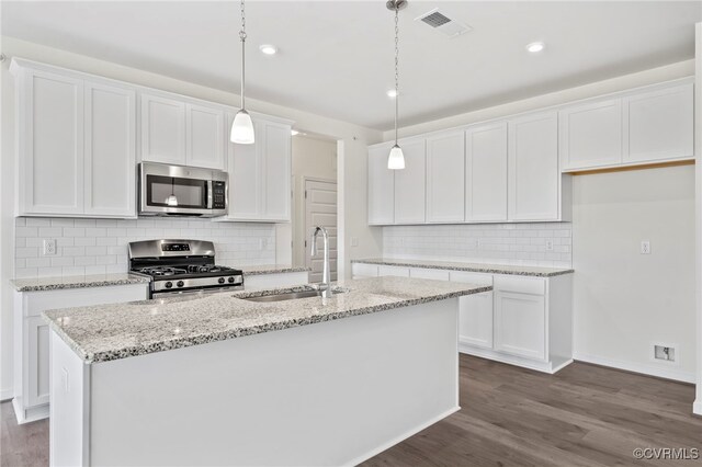 3817 Maze Runner Dr, Midlothian, VA 23112 - kitchen featuring an island with sink, appliances with stainless steel finishes, pendant lighting, and white cabinets