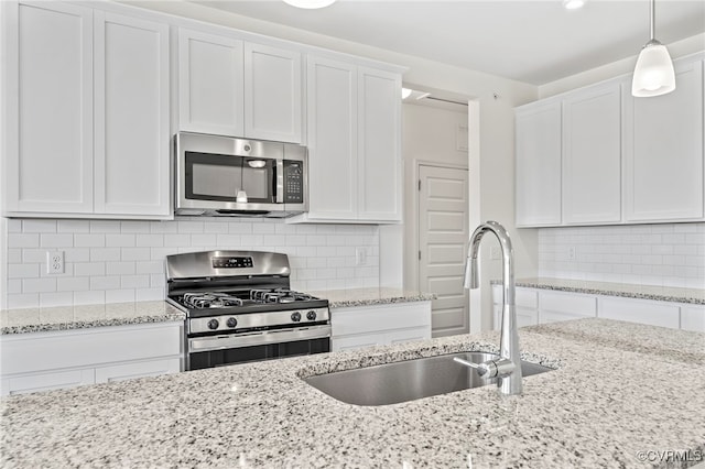 3817 Maze Runner Dr, Midlothian, VA 23112 - kitchen featuring stainless steel appliances, sink, white cabinets, and decorative light fixtures