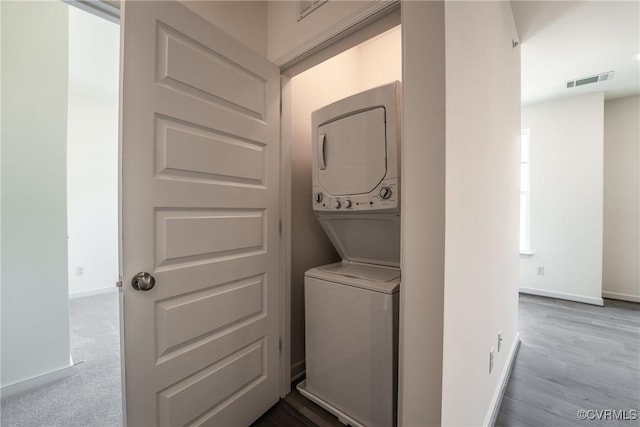 laundry room featuring stacked washer and clothes dryer