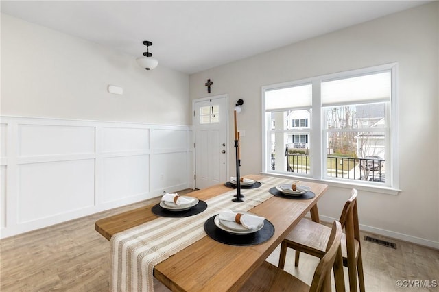 dining space featuring light wood-type flooring