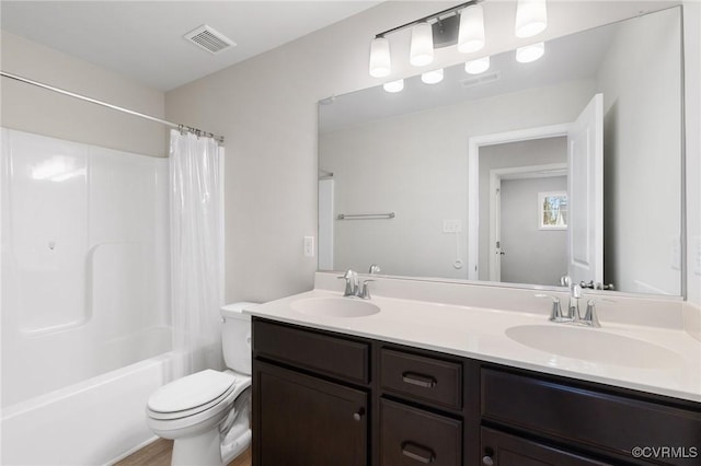 full bathroom with vanity, toilet, and shower / tub combo