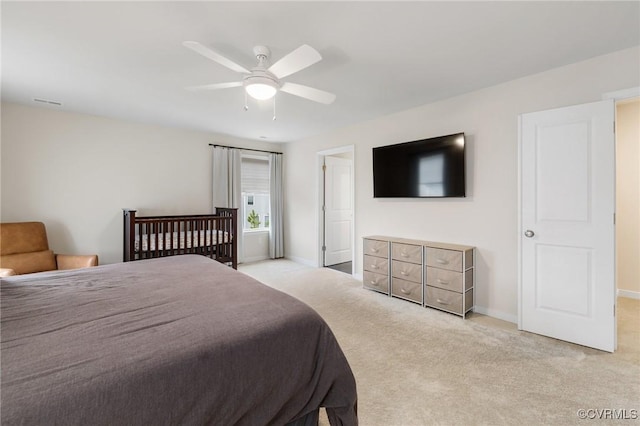 bedroom with ceiling fan and light colored carpet