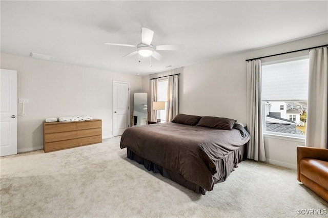 bedroom featuring light carpet and ceiling fan