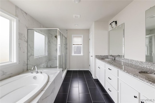 bathroom with vanity and shower with separate bathtub