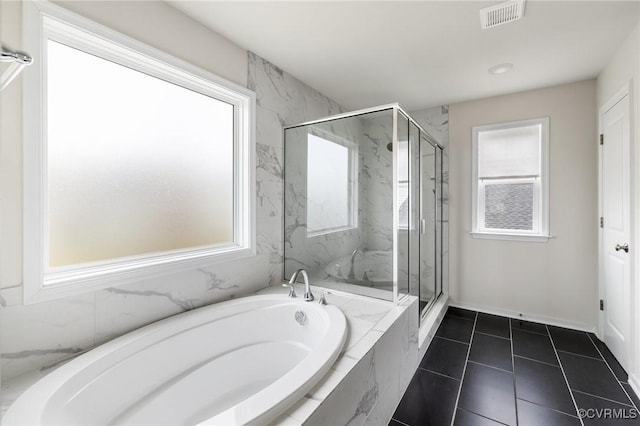 bathroom with independent shower and bath and tile patterned floors