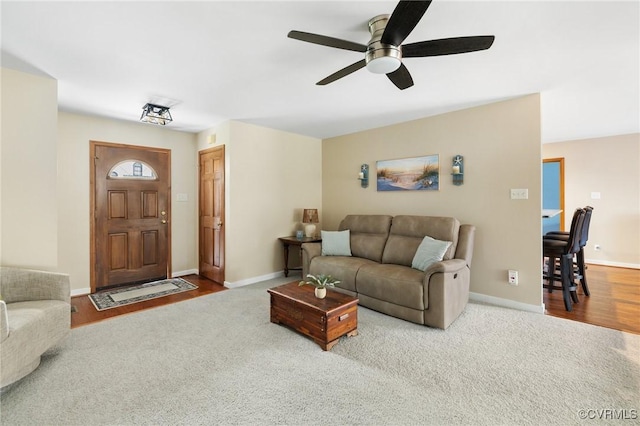 carpeted living room featuring ceiling fan