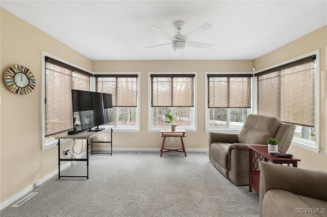 interior space with ceiling fan