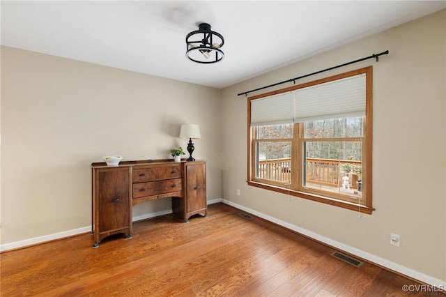 office with light wood-type flooring