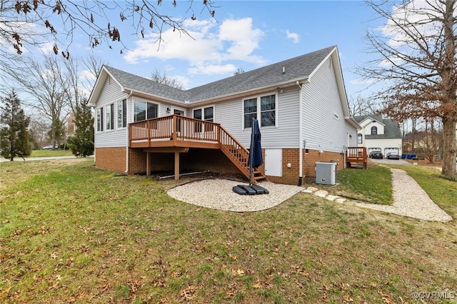 rear view of house featuring a wooden deck, a yard, and central air condition unit