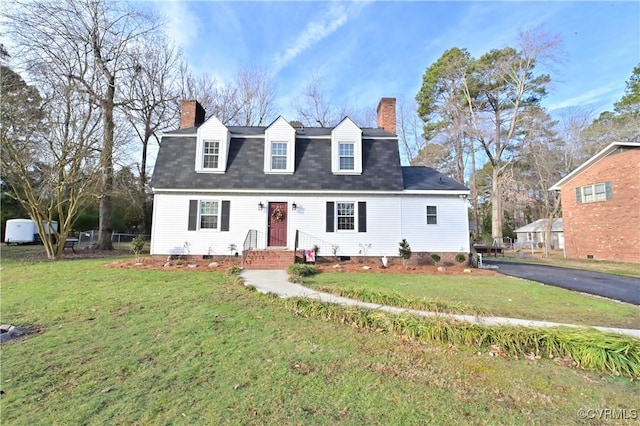 cape cod home with a front yard