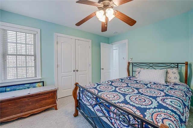 carpeted bedroom with a closet and ceiling fan