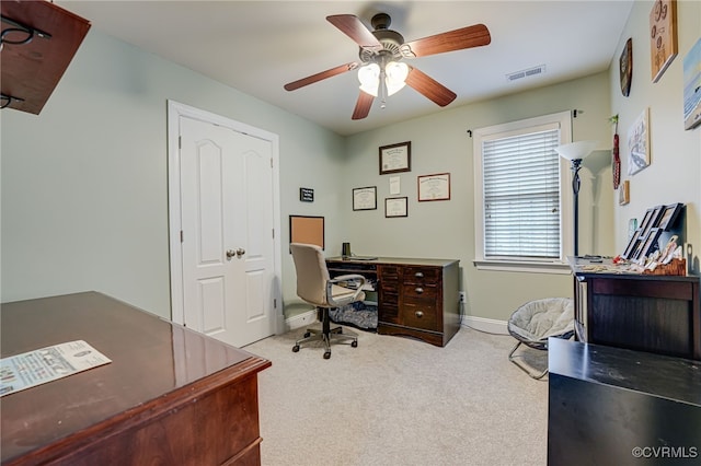 home office with ceiling fan and carpet