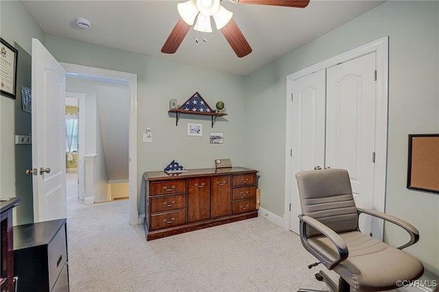 carpeted home office with ceiling fan