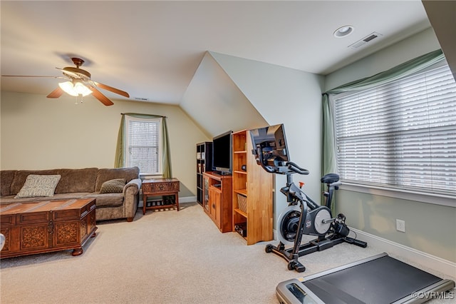 exercise area featuring vaulted ceiling, ceiling fan, and carpet