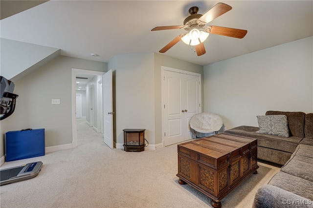 carpeted living room featuring ceiling fan