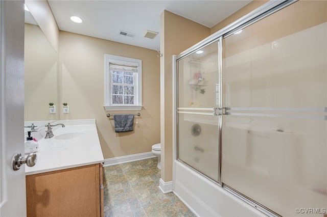 full bathroom featuring shower / bath combination with glass door, vanity, and toilet