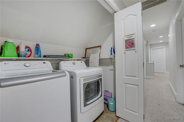 laundry room with washer and dryer and light carpet