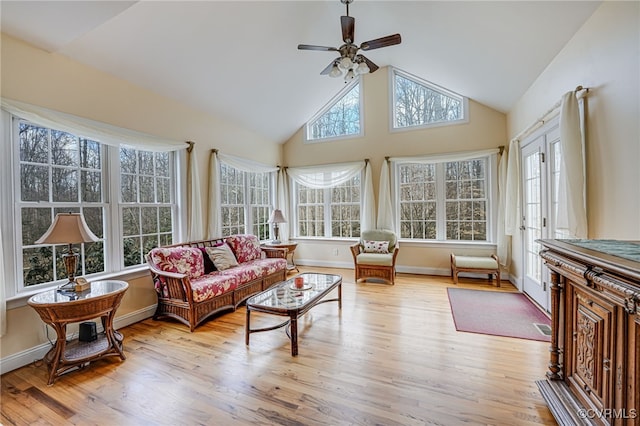 sunroom featuring lofted ceiling and ceiling fan