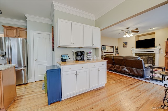 kitchen with white cabinetry, light hardwood / wood-style floors, ceiling fan, and stainless steel refrigerator with ice dispenser